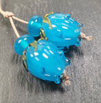 These flower bud beads are made with a core of Andrew with Effetre light aqua petals over the top.