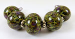 Cobblestone wrapped with fine silver foil and rolled in Pendragonfyre blended frit