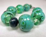 Celadon shards over Appletini and Sherwood base beads