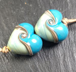CiM Pachamama with Effetre dark turquoise glass and silvered ivory stringer