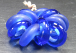 Half of these Sacre Bleu hoops have been tumbled etched with silicon carbide grit in a rock tumbler to give them a sea glass finish.