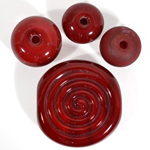Top left to right: Maroon over white, non-encased bead, etched bead