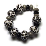 Butter Pecan with leopard spots in Adamantium and Hades, encased in Clear. Spacers are Tuxedo and Cobblestone.