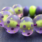 CiM Oobleck encased in Effetre transparent Dark Lavender 081, and decorated with spots in CiM Lapis and Oobleck. Tumble-etched.