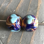 Baked Alaska rolled in Val Cox's newest 104 Silver Glass frit blend, Elsie encased and Little Boy Blue hearts